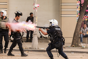 A police officer fires teargas on June 17, 2013.
© 2013 Miguel Carminati
