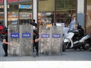 Police hide behind their shields in Taksim