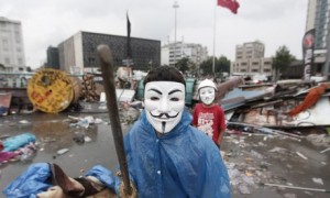 A boy wearing a Guy Fawkes mask in Gezi Park