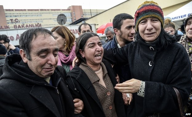 Berkin Elvan's mother (C) was surrounded by mourners outside the hospital on Tuesday