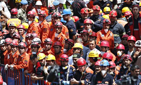 Miners and rescue workers await the arrival of Turkey’s president, Abdullah Gül, outside the mine in Soma. Photograph: Lefteris Pitarakis/AP